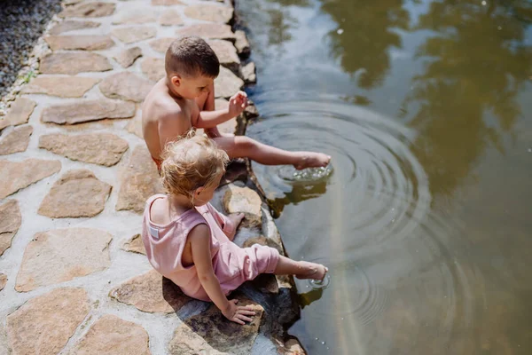 Cute Girl Boy Sitting Together Footpath Lake Dangle Feet Water — 스톡 사진