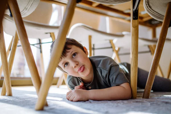 Lttle Boy Hiding Chair Home Making Grimace — Fotografia de Stock
