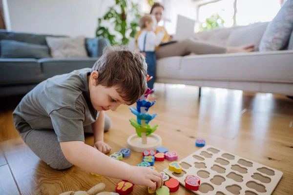 Little Boy Playing Montessori Wooden Toys Living Room Mother Sister — Foto de Stock