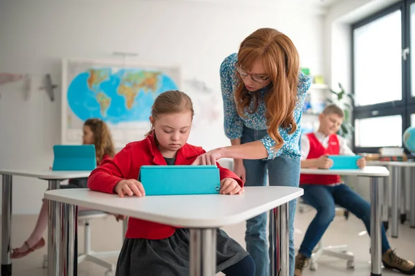 Syndrome Schoolgirl Using Tablet Help Teacher Class School Integration Concept — стоковое фото