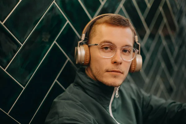 Mature Man Headphones Enjoying Listening Music Indoors Dark Tiled Wall — Stock Fotó