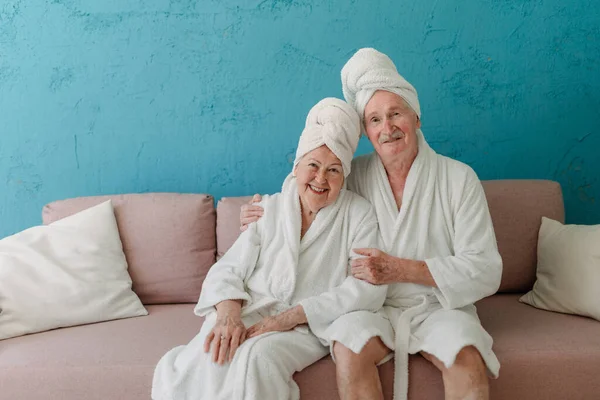 Happy Senior Couple Sitting Together Bathrobe Sofa Having Nice Time — Fotografia de Stock