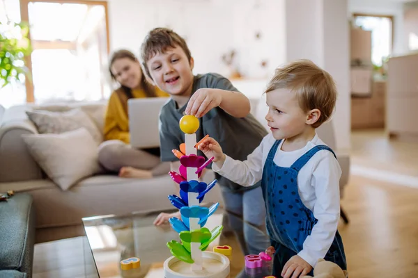 Little Siblings Playing Wooden Toys Living Room Mother Sitting Sofa — Stok fotoğraf