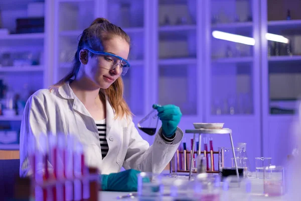 A science student doing chemical experiment in the laboratory at university.