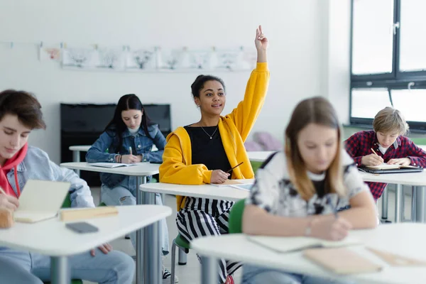 High School Students Paying Attention Class Sitting Desks Raising Hands — Stock Photo, Image