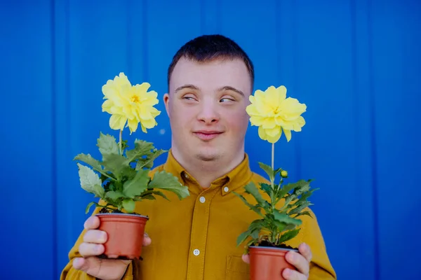 Happy Young Man Syndrome Looking Camera Holding Pot Flowers Blue — Stock Photo, Image