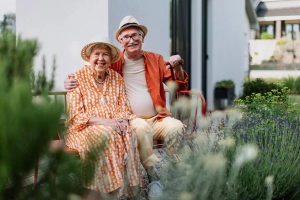 Happy Senior Couple Sitting Together Garden Bench Smiling Looking Camera — Stock Fotó