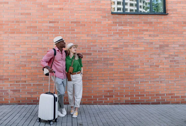 Young Biracial Couple Travelling Together Suitcases Posing Front Brick Wall —  Fotos de Stock