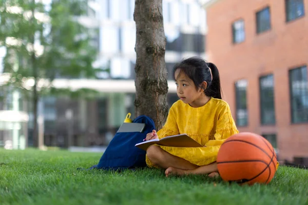 Little Asian Girl Sitting Public Park Writing Some Notes Summer — Fotografia de Stock