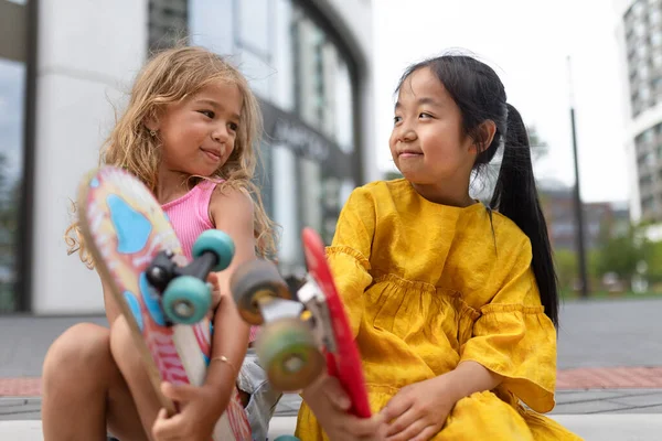 Two Girls Sitting Holding Skateboards City Street Active Kids Concept — Stock Fotó