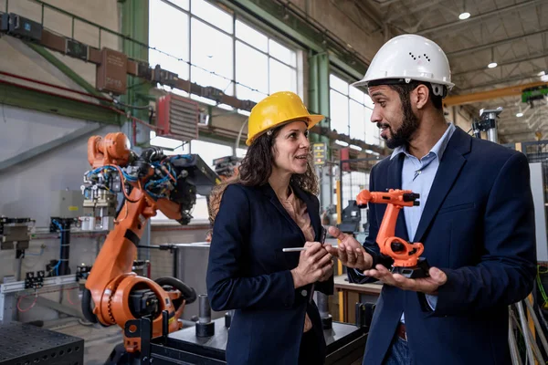 Man Engineer Holding Model Industrial Robotic Arm Showing Collegue Factory — Stock Fotó
