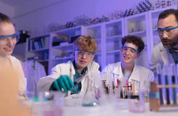 Science students doing a chemical experiment in the laboratory at university.