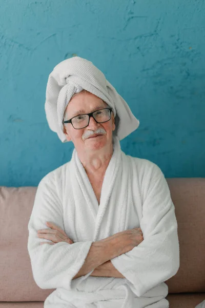 Happy Senior Man Glasses Sitting Sofa Bathrobes Looking Camera — Foto Stock