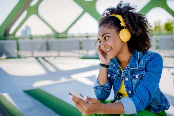 Multiracial Teenage Girl Backpack Headphones Smartphone Resting School City Bridge — Zdjęcie stockowe