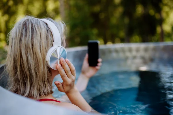 Reaxed Woman Headphones Listening Music Outdoor Bathtub Rear View — Stockfoto
