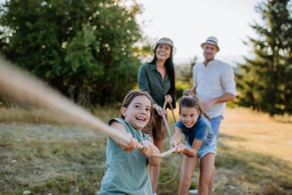 Young Family Happy Kids Having Fun Together Outdoors Pulling Rope — Photo