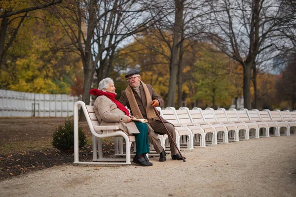 Happy Senior Friends Sitting Bench Talking Outdoors Park Autumn Day — стоковое фото