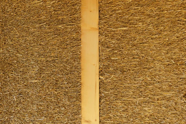 Close-up of straw-wooden detail at construction of an ecological renewable low energy sustainable wooden eco house.