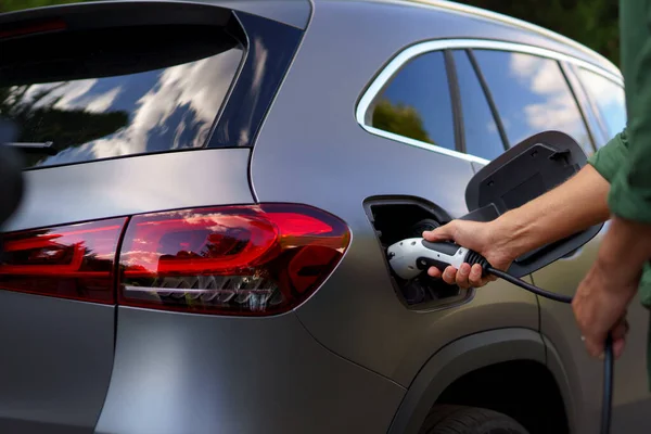 Man Holding Power Supply Cable Electric Vehicle Charging Station Closeup — Foto de Stock