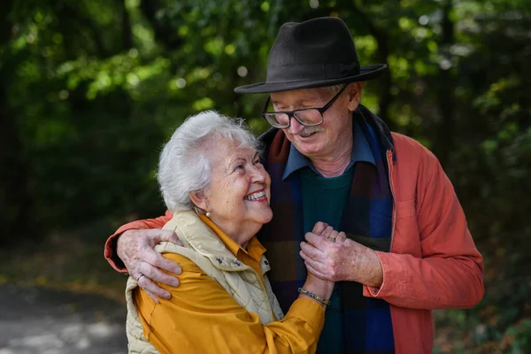 Portrait of senior couple in love at walk in a park.