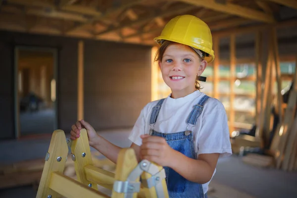 Happy Little Girl Helping Unfinished Wooden House Standing Ladder Helmet — Stock Photo, Image