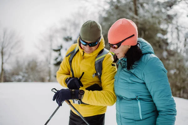 Oudere Stellen Kijken Naar Een Smartwatch Tijdens Het Winterskiën — Stockfoto