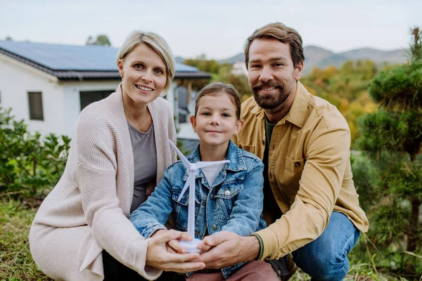 Happy Family Holding Plastic Model Wind Turbine Alternative Energy Saving — Stock Photo, Image