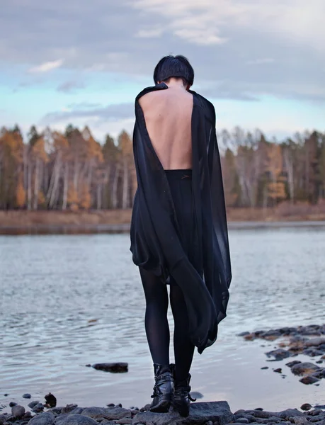 Woman in black near river — Stock Photo, Image