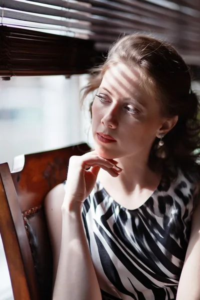 Young lady at the window of a cafe — Stock Photo, Image