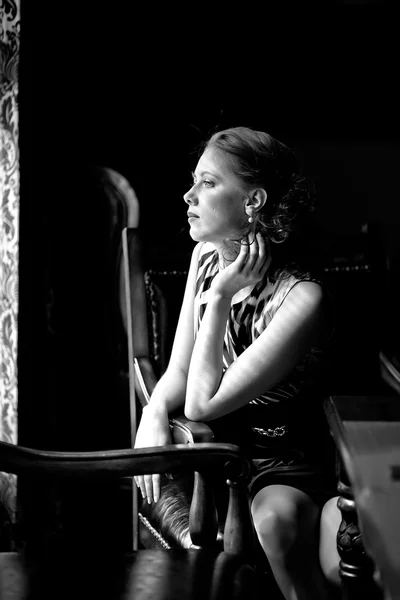 Young lady at the window of a cafe Stock Photo