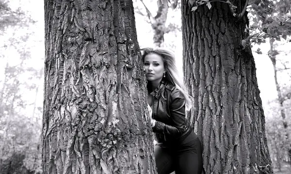 Kobieta pozowanie między drzewami — Zdjęcie stockowe