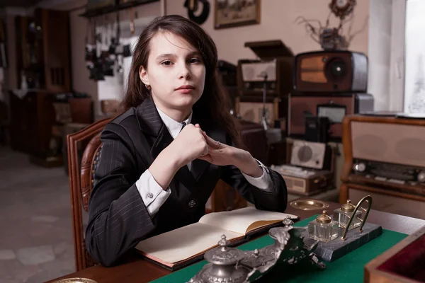 Girl sat in antique shop — Stock Photo, Image