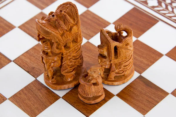 Indian sandalwood chess pieces on a board