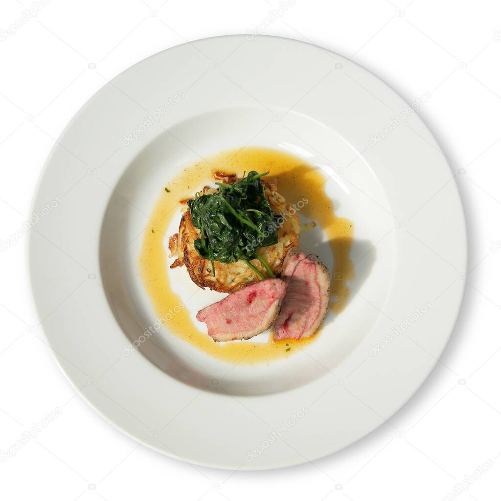 White diner plate with lamb loin spinach and potato rosti