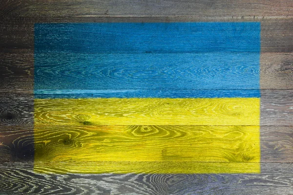 Ukraine flag on rustic old wood surface background — Stock Photo, Image