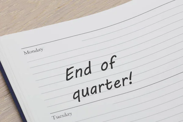An end of quarter reminder note in a diary page