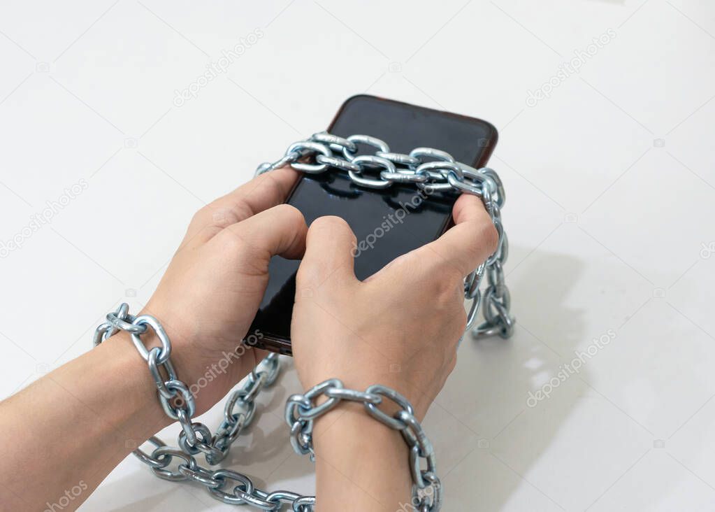 Mobile phone chained social media concept to the hands telephone 