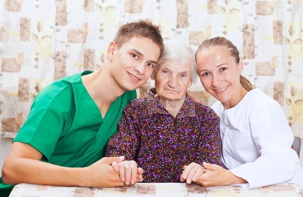 Elderly woman with the young doctor — Stock Photo, Image