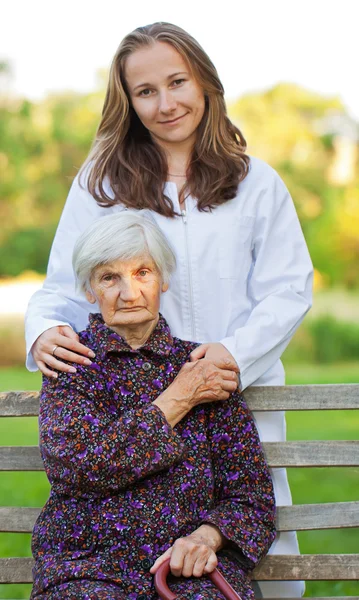 Elderly woman with the young doctor — Stock Photo, Image