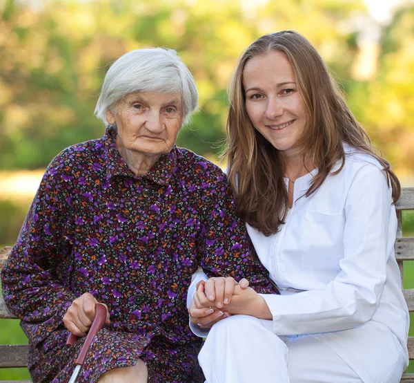 Elderly woman with the young doctor — Stock Photo, Image