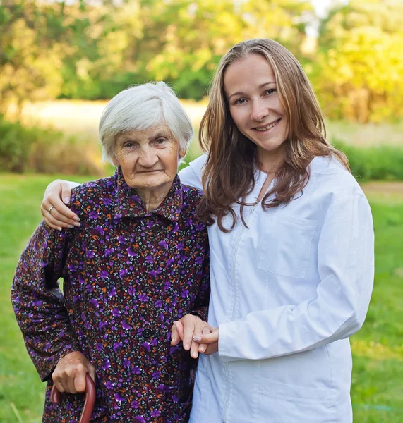 Elderly woman with the young doctor — Stock Photo, Image