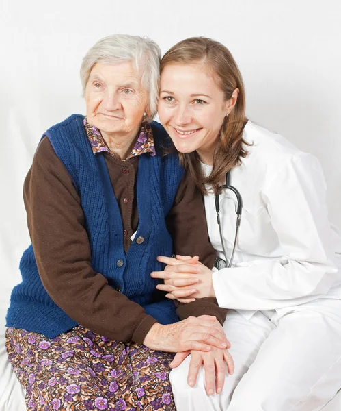 Old woman and the sweet young doctor staying together — Stock Photo, Image