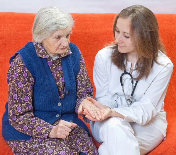 Old woman and the sweet young doctor staying together — Stock Photo, Image
