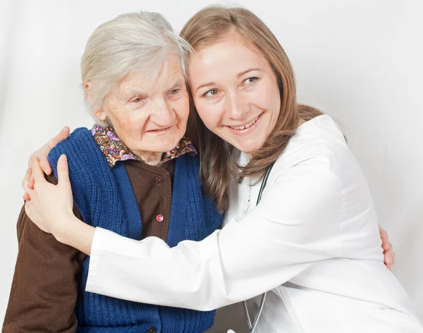 Old woman and the sweet young doctor staying together — Stock Photo, Image