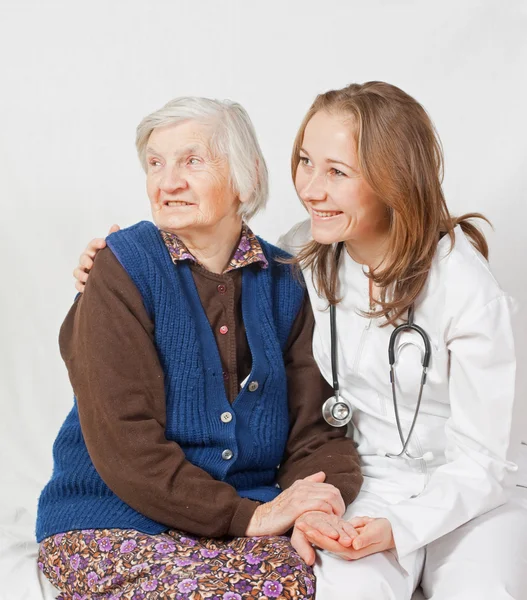 Old woman and the sweet young doctor staying together — Stock Photo, Image