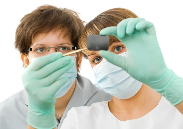 Sweet young doctor examine the dental Rx — Stock Photo, Image