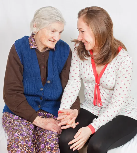 The sweet young girl and the old woman staying together Stock Photo