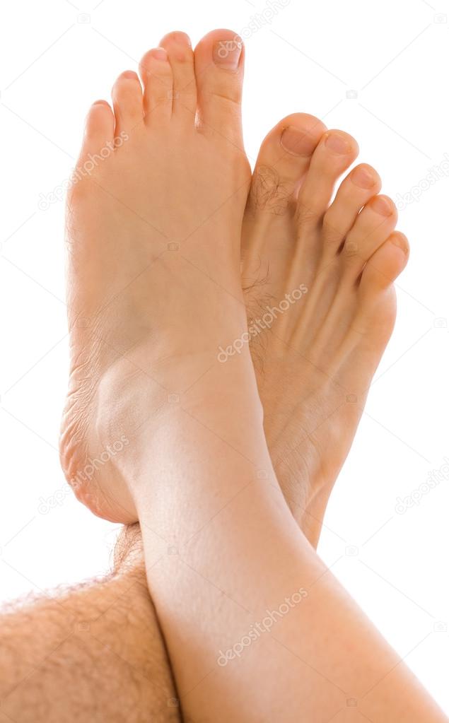 Young couples foot on each other