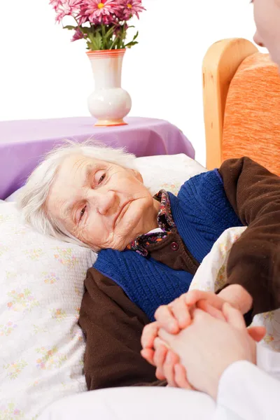 Elderly lonely woman rests in the bed — Stock Photo, Image