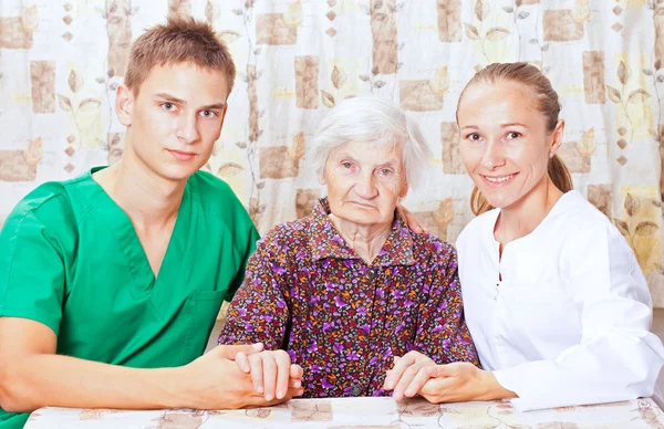 Elderly woman with the young doctor — Stock Photo, Image